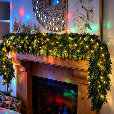 9 FT Pre-Lit Artificial Cedar Garland with LED Lights & Auto Timer, Flexible Wire Core Greenery Garland for Mantel, Fireplace, Stair Railing, Indoor Outdoor Christmas Decor