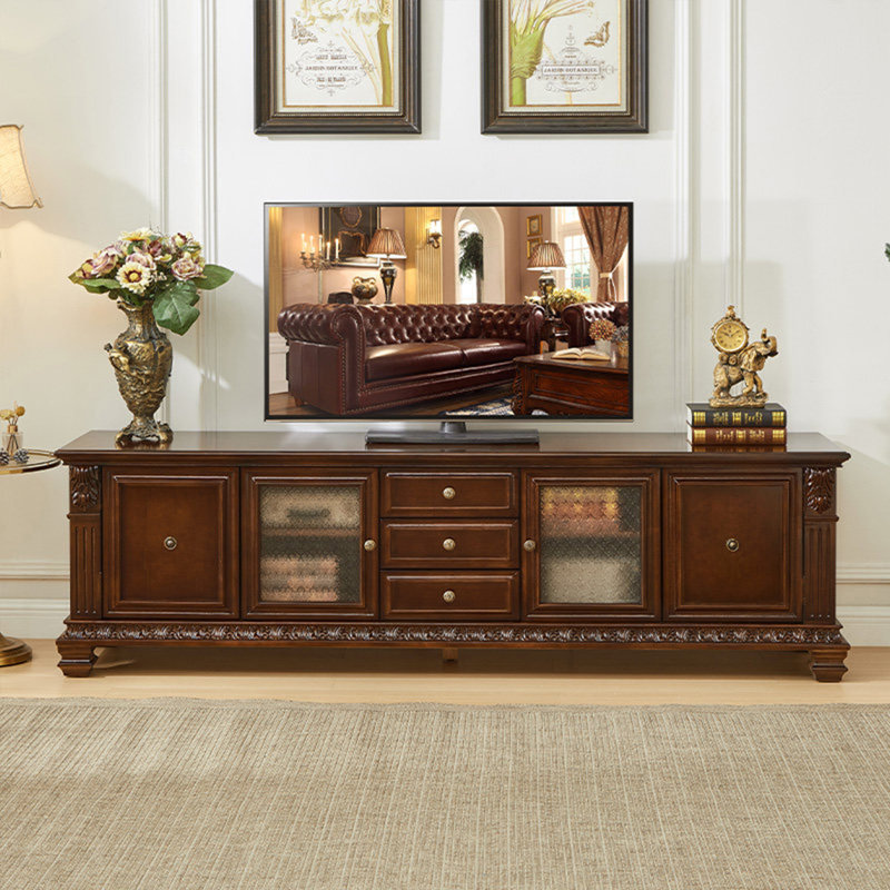 Meuble télé vintage en acajou brun sculpté, style colonne romaine, autoportant, avec grande capacité de rangement.