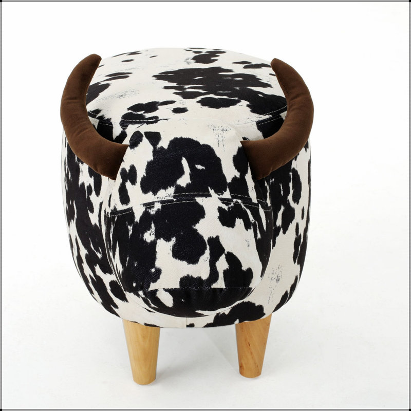 Charmant repose-pieds en forme de vache, tabouret d'appoint moderne avec des cornes de velours et des pieds en bouleau pour une décoration polyvalente