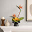 Arrangement artificiel oiseau de paradis et orchidée dans un vase en céramique noire