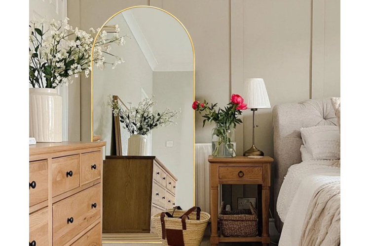 gold arch-framed mirror in contemporary bedroom