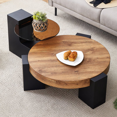 Table basse ronde moderne simple à double couche - Plateau en verre brun transparent avec pieds en panneau de fibres à densité moyenne noirs en forme de L. La conception détachable peut rendre l'utilisation de l'espace plus flexible.