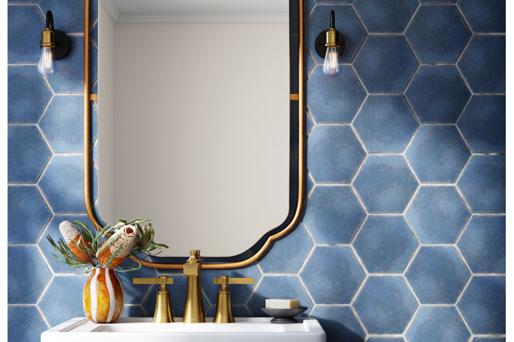 blue honeycomb wall tile in a bathroom featuring a beautiful gold wall mirror