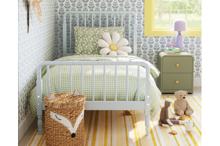 kids bedroom with a light blue spindle bed, gingham and floral bedding, and floral wallpaper