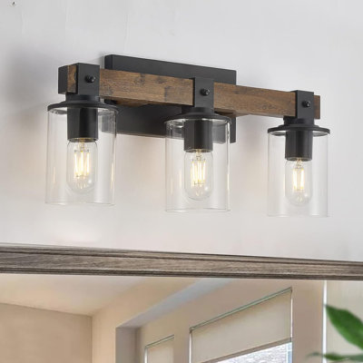 Éclairage pour meuble-lavabo de salle de bain 6 lumières avec abat-jour en verre transparent Addae, lumières murales noires et dorées Addae
