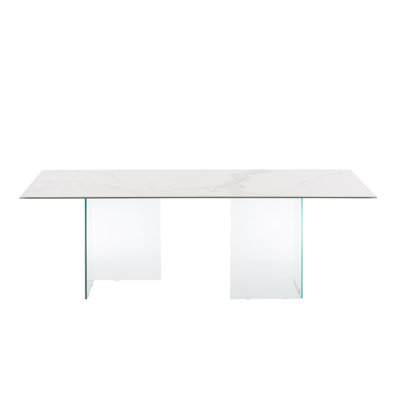 Table de salle à manger Miami avec base transparente et plateau en porcelaine marbrée blanche.