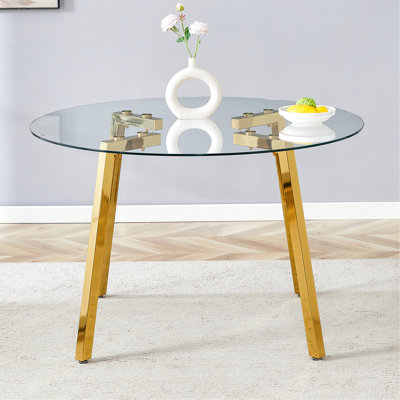 Table de salle à manger moderne et luxueuse en verre trempé avec pieds dorés, rehaussant votre espace