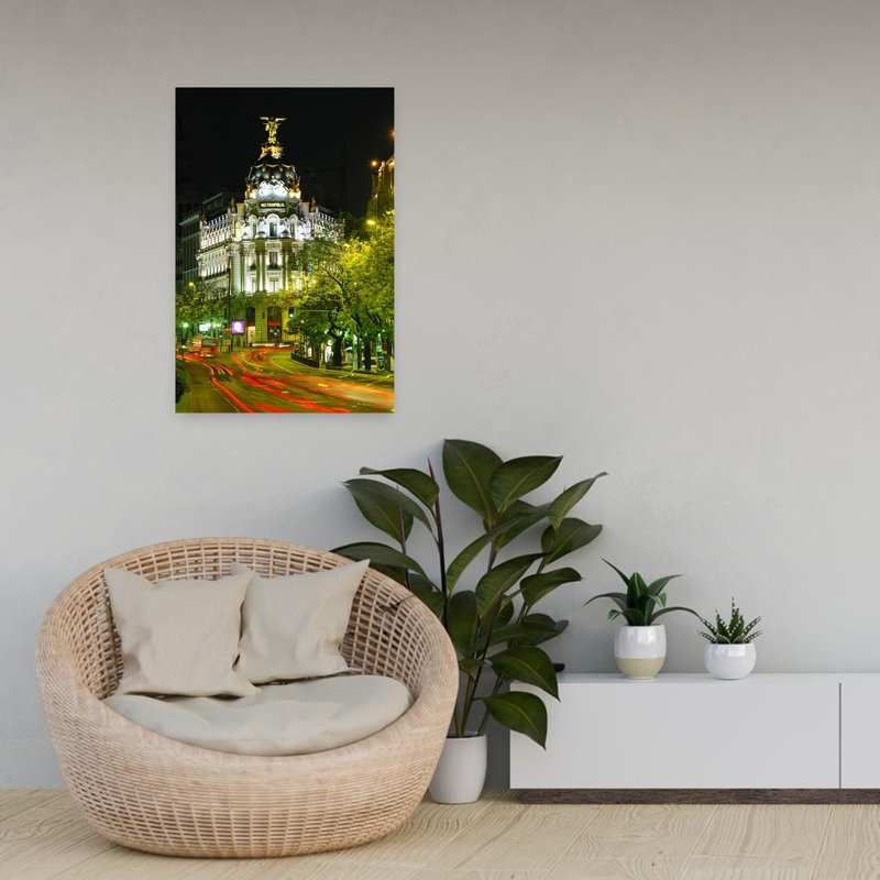 Metropolis Building At Night And Light Trails On Street Madrid Spain by Miles Ertman - Wrapped Canvas Print