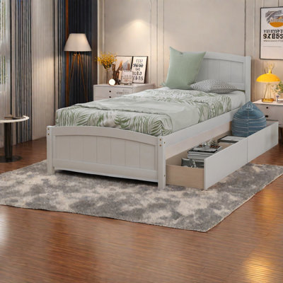 Lits simples blancs peu encombrants, structure en bois massif avec tiroirs de rangement