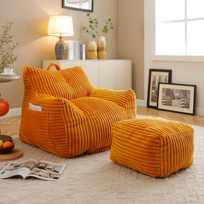Fauteuil à billes en peluche avec accoudoirs et repose-pieds pour une détente ultime