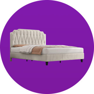 Cream-coloured upholstered bed frame with a tufted, scalloped headboard on a solid purple circular background.