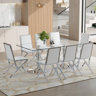 Ensemble de table et de chaises. 71 x 35,4 pouces en verre trempé, 8 chaises de salle à manger en polyuréthane blanc avec cadre en métal argenté. Table de cuisine moderne et ensemble de mobilier de salle à manger 8 places pour les réunions de famille.