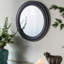 Miroir mural circulaire avec cadre en bois noir