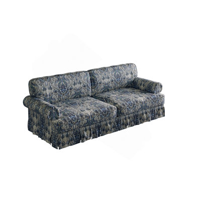 Canapé à assise profonde luxueusement confortable avec accoudoirs roulés et jupe plissée, idéal pour un appartement ou un bureau.