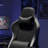 Black High-Back Ergonomic Chair, Suitable For Both Gaming And Office Work, Featuring An Individually Pocketed Spring Seat, Linked Armrests, Footrest, And Lumbar Support.