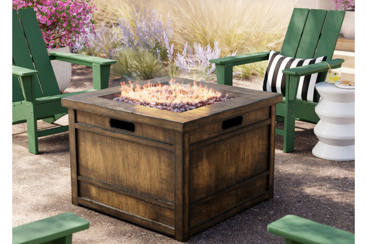 wood fire pit table with four green adirondack chairs