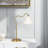 Ornate Brass Ring Base Curved Table Lamp with Triangle White Drum Shade