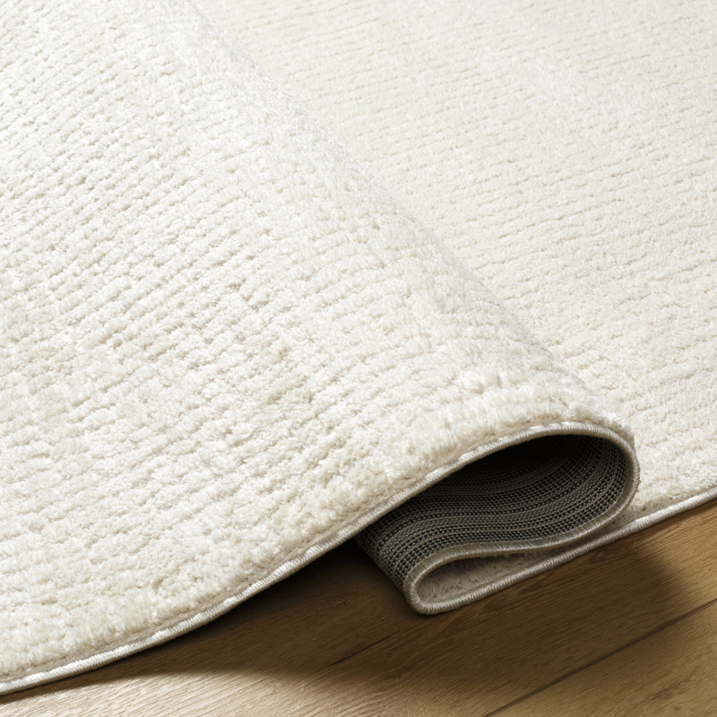 Arny Solid Color Machine Woven Polyester Area Rug in Cream