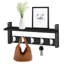 Black wall-mounted floating shelf with five white hooks, styled with a vase, picture frame, handbag, and keys.