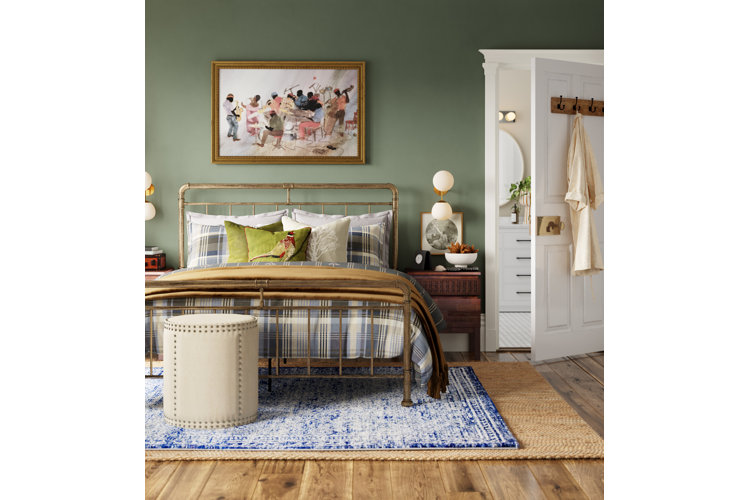 Green bedroom idea featuring solid green walls, a gold metal bed, blue plaid bedding, and green throw pillows.