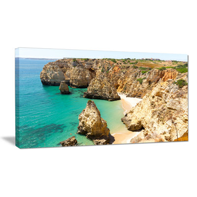 «Rocky and Rough Portugal Bay», reproduction de photo sur toile tendue en bleu / beige