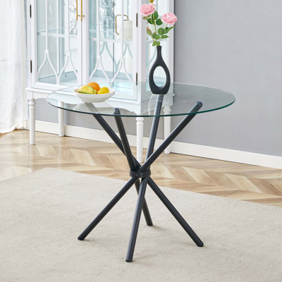 Table ronde moderne en verre avec base en métal noir entrelacé