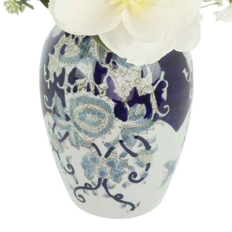 Magnolia and Delphinium Arrangement in a Decorative Ceramic Vase