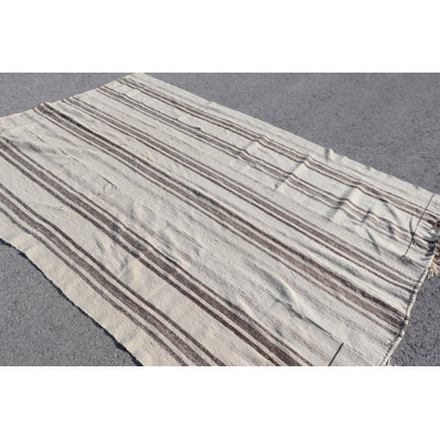 Tapis Kilim authentique en laine fabriqué à la main avec des rayures vibrantes, parfait pour un décor rustique