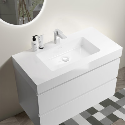 Meuble-lavabo élégant avec tiroirs doubles et conception sans poignée, offrant beaucoup de rangement et un look moderne.
