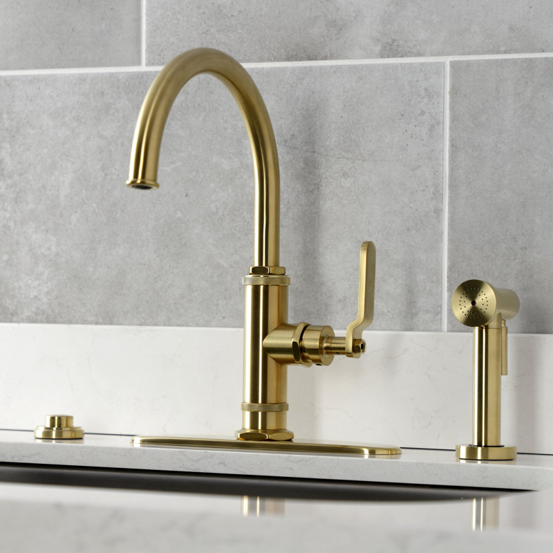Kingston Brass Whitaker Single-Handle Deck Mount Kitchen Faucet with Brass Sprayer, Brushed Brass
