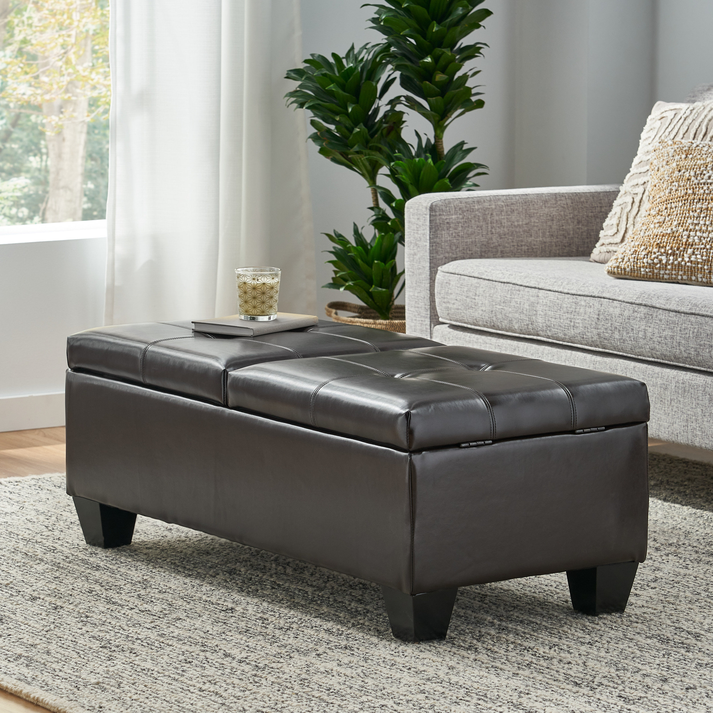 A large leather ottoman with storage, perfect for stashing away clutter