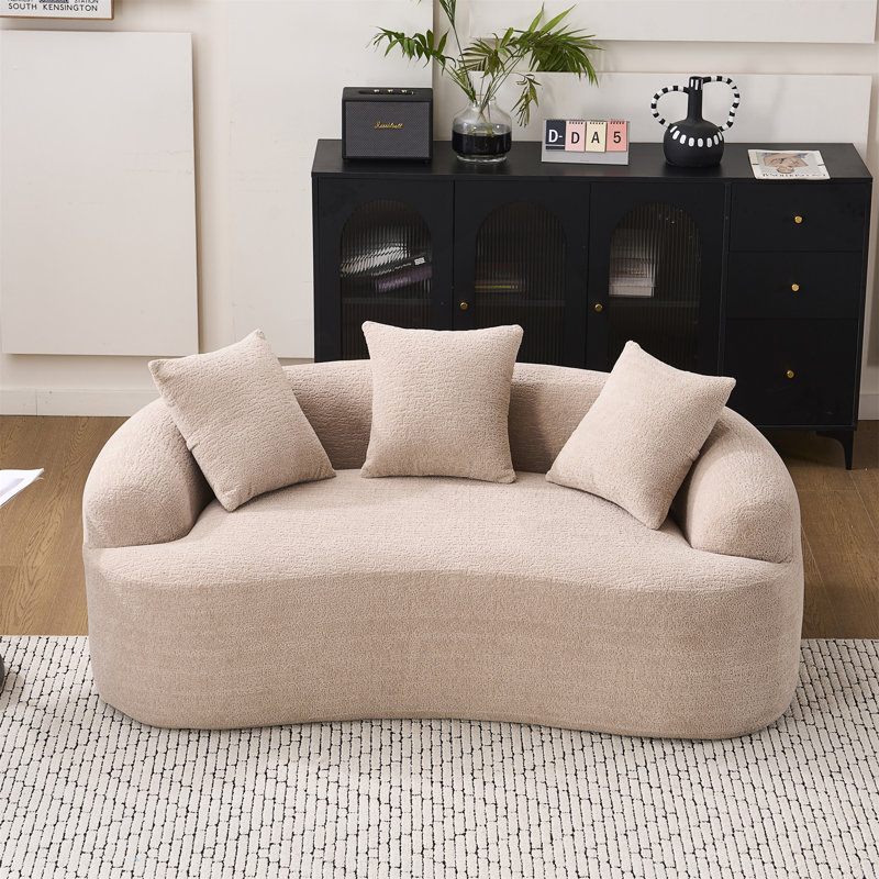 Canapé courbé avec 3 coussins décoratifs