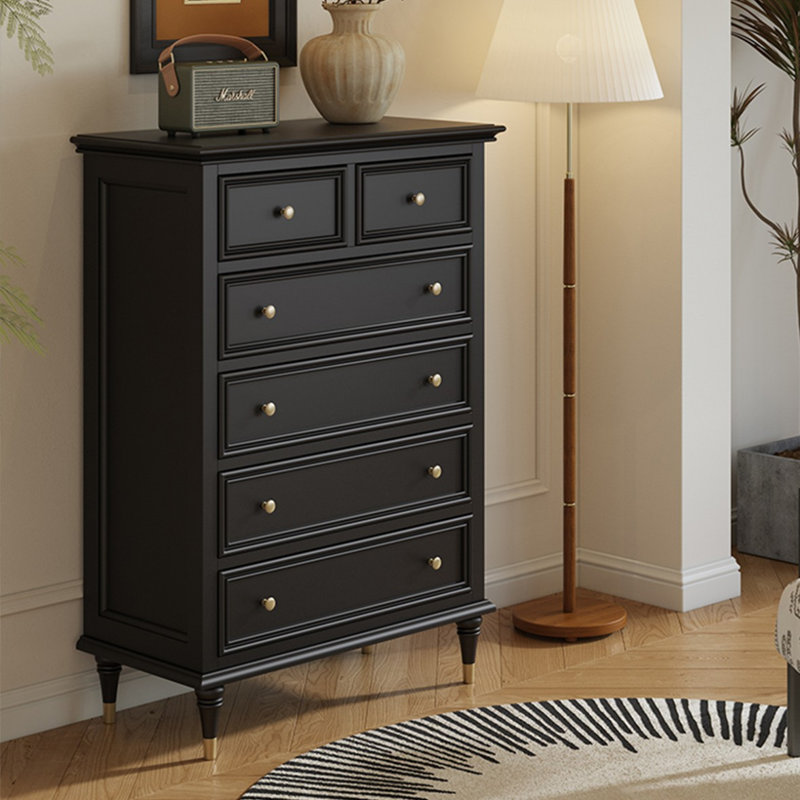 Armoire cinq tiroirs en bois massif noir avec pattes décoratives dorées