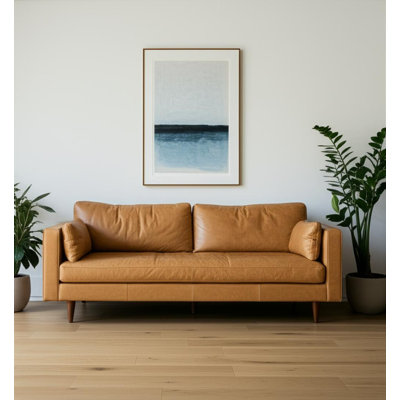 88" Tan Leather Sofa And Toss Pillows With Brown Legs