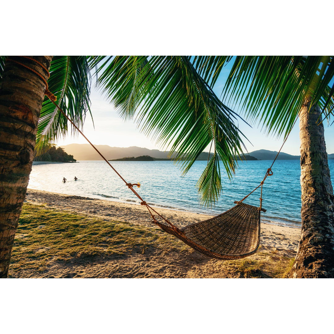 Leinwandbild Hammock Between Two Palm Trees On The Beach At Sunset