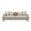Canapé moderne en tissu beige avec base en métal doré et coussins décoratifs