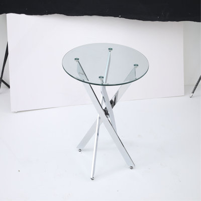 Le plateau de table circulaire en verre trempé moderne est jumelé à un cadre en fer mesurant 35,43 pouces de longueur.