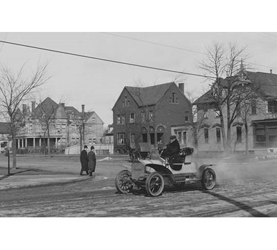 " Auto Trundles Down City Street "