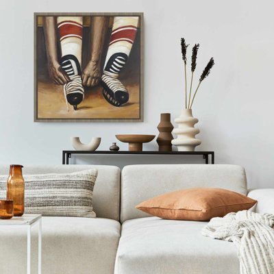Hockey Player Ties Skates Framed Canvas | Sports Home Decor