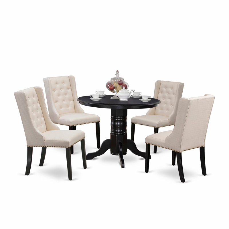 L'ensemble de table de cuisine 5 pièces pour 4 personnes comprend une table de salle à manger ronde avec piédestal et 4 chaises rembourrées en tissu crème, noir