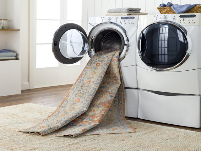 Machine washable rug inside washing machine with suds