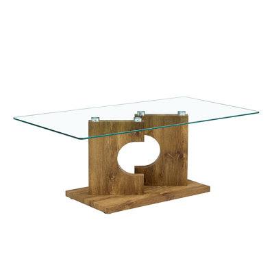 Une table basse rectangulaire moderne et tendance avec un plateau en verre trempé et des pieds en bois aggloméré.