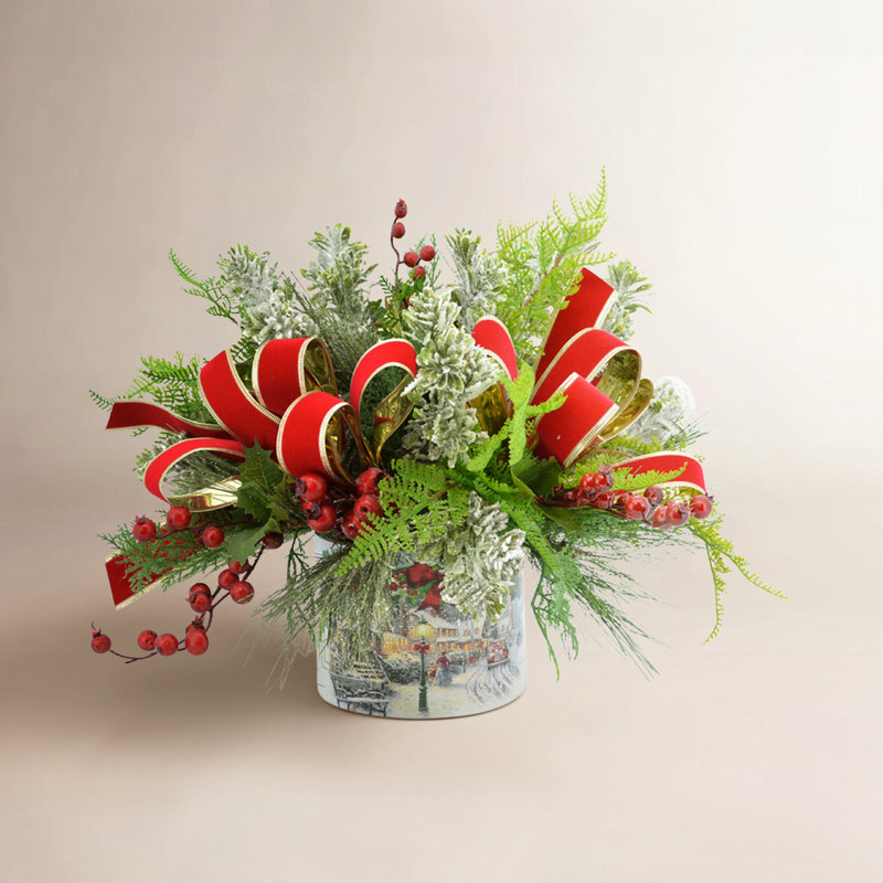 Festive holiday arrangement with greens and Berries