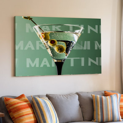Toile, verre à martini élégant et élégant rempli d'un cocktail d'art scintillant mettant en vedette deux olives vertes sur une brochette posée sur une toile