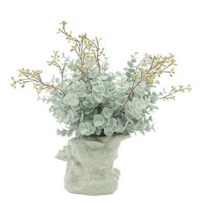 Eucalyptus Arrangement In A Shell Vase.