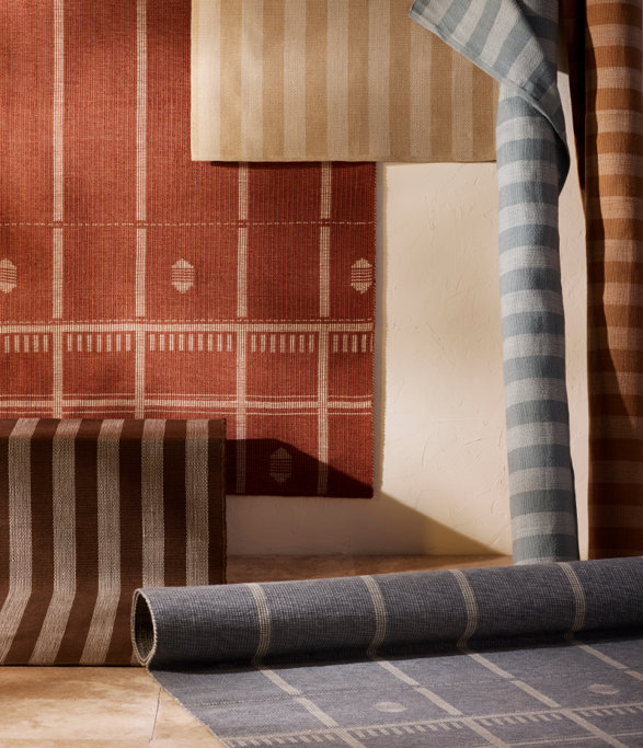 Various colored striped and patterned rugs.