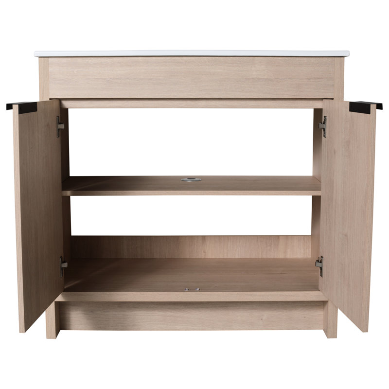 Coffre de salle de bain autoportant 36 pouces. Évier en céramique et 2 portes d'armoire à fermeture en douceur. Soupçon de chêne brut. Tablette réglable. Poignées en métal. Ensemble de meuble-lavabo Hardy Scintillant distinctement.