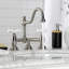 Kingston Brass Restoration Two-Handle 3-Hole Deck Mount Bridge Bathroom Faucet with Brass Pop-Up-64005520