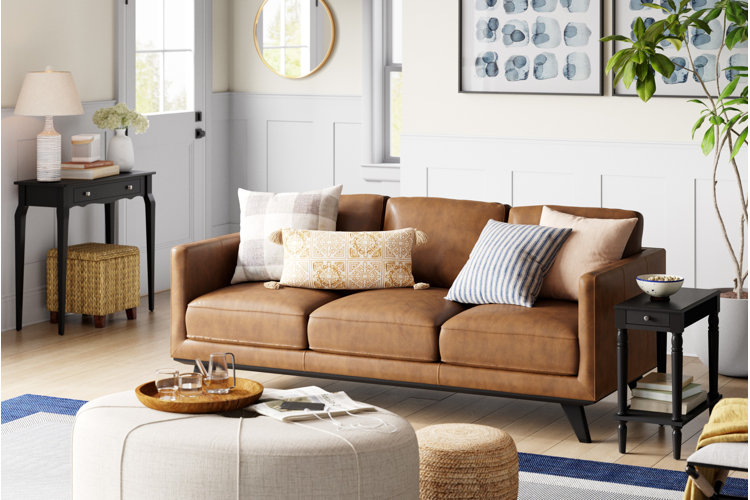 brown leather sofa and black end tables in a traditional living room