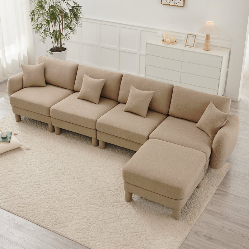 Canapé modulaire en L convertible pour 4 personnes avec accoudoirs en forme de coquillage et repose-pieds amovible Boucle
